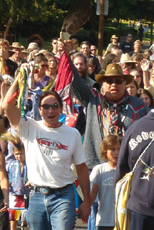 Dan Wahpepah and David West lead the ceremonial walk to the sculpture dedication